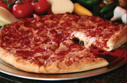 A pepperoni pizza with a slice being pulled away, showing melted cheese.