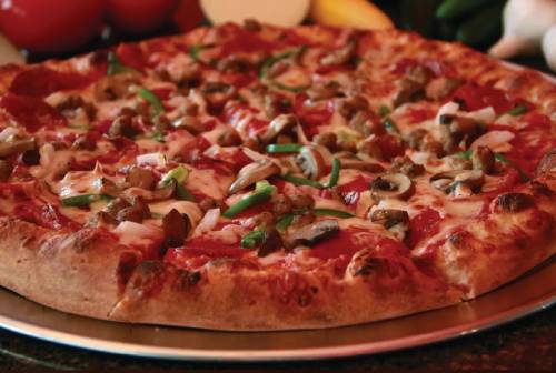 A delicious pizza topped with mushrooms, green peppers, and sausage.